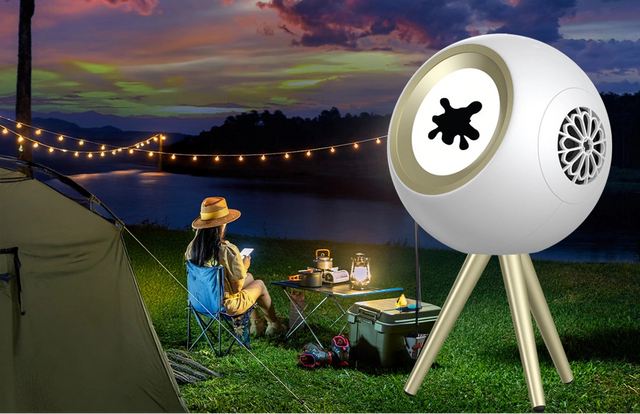 Ferrofluid Bluetooth speaker with dancing magnetic liquid visualizer, RGB lighting, and sleek glass chamber on tripod stand outdoors.